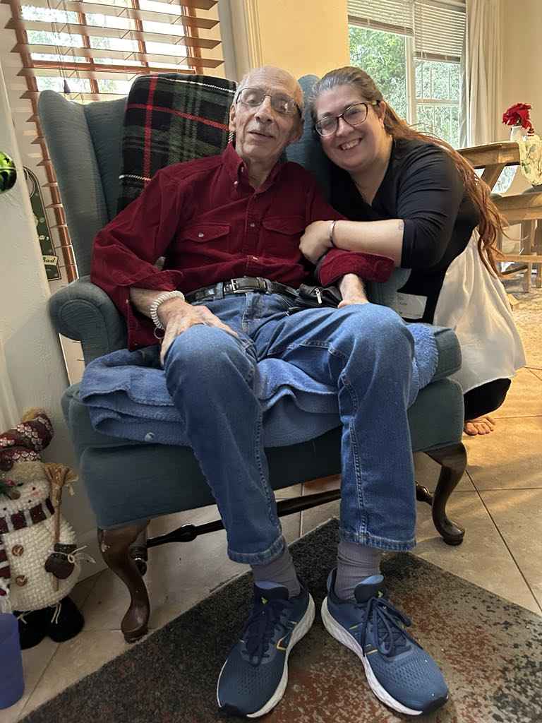 Caregiver and senior client sharing a friendly moment and companionship.